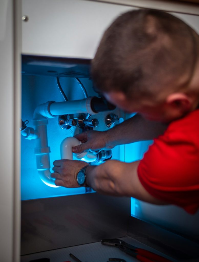 Plumber repairing a pipe